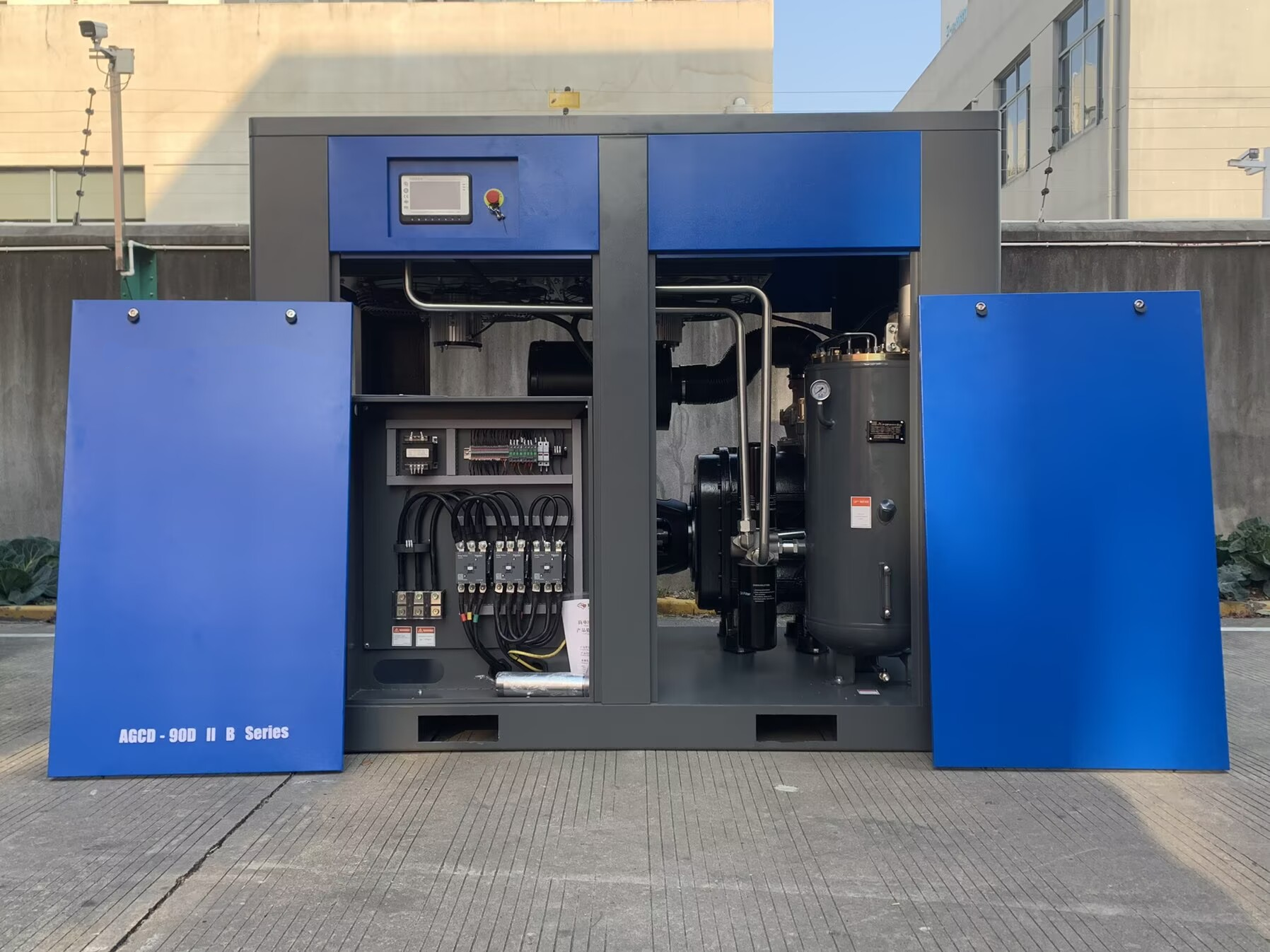 Industrial screw air compressor unit showing motor and cooling system