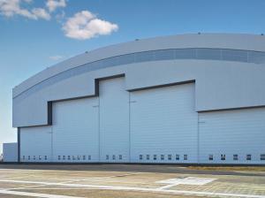 China Prefab Curve Roofing System Steel Aircraft Hangars With Electrical Slide Doors on sale