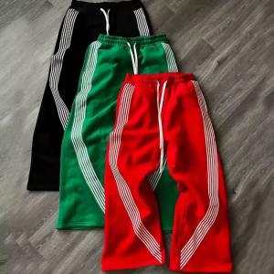 China Custom Logo Jogger Graphic Embroidered Patches Webbing Trimmed Wide Leg Design Track Pants Oversized Nylon Flared Sweatpants on sale